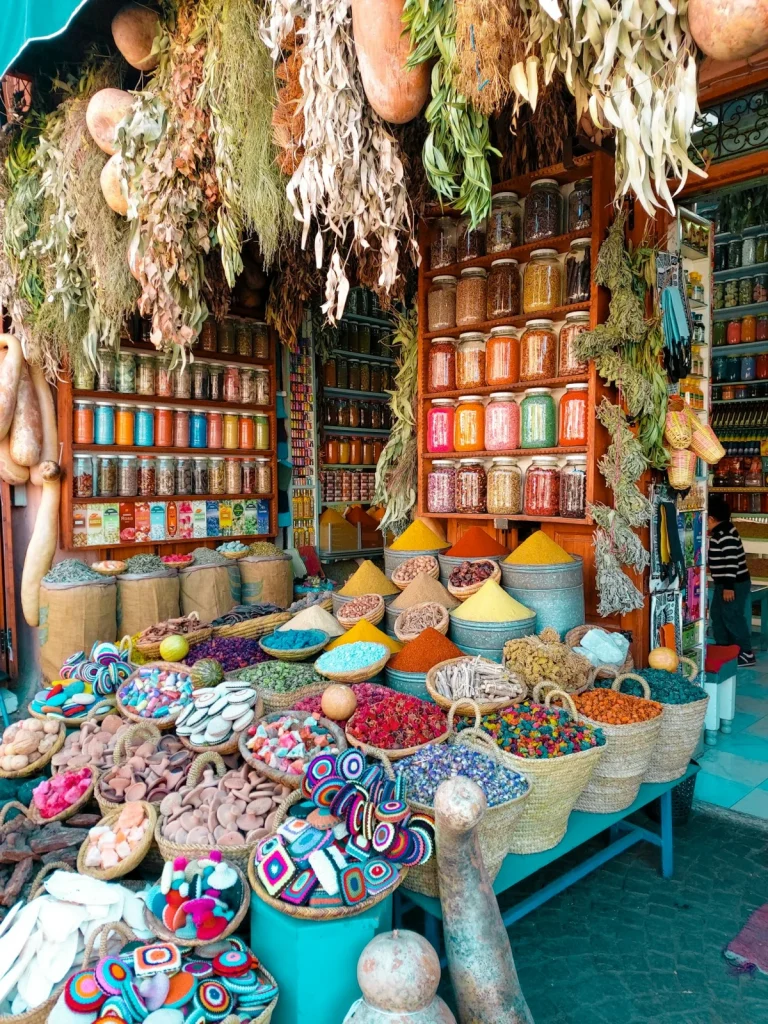 Baskets of spices and dried flowers at a Moroccan market stall