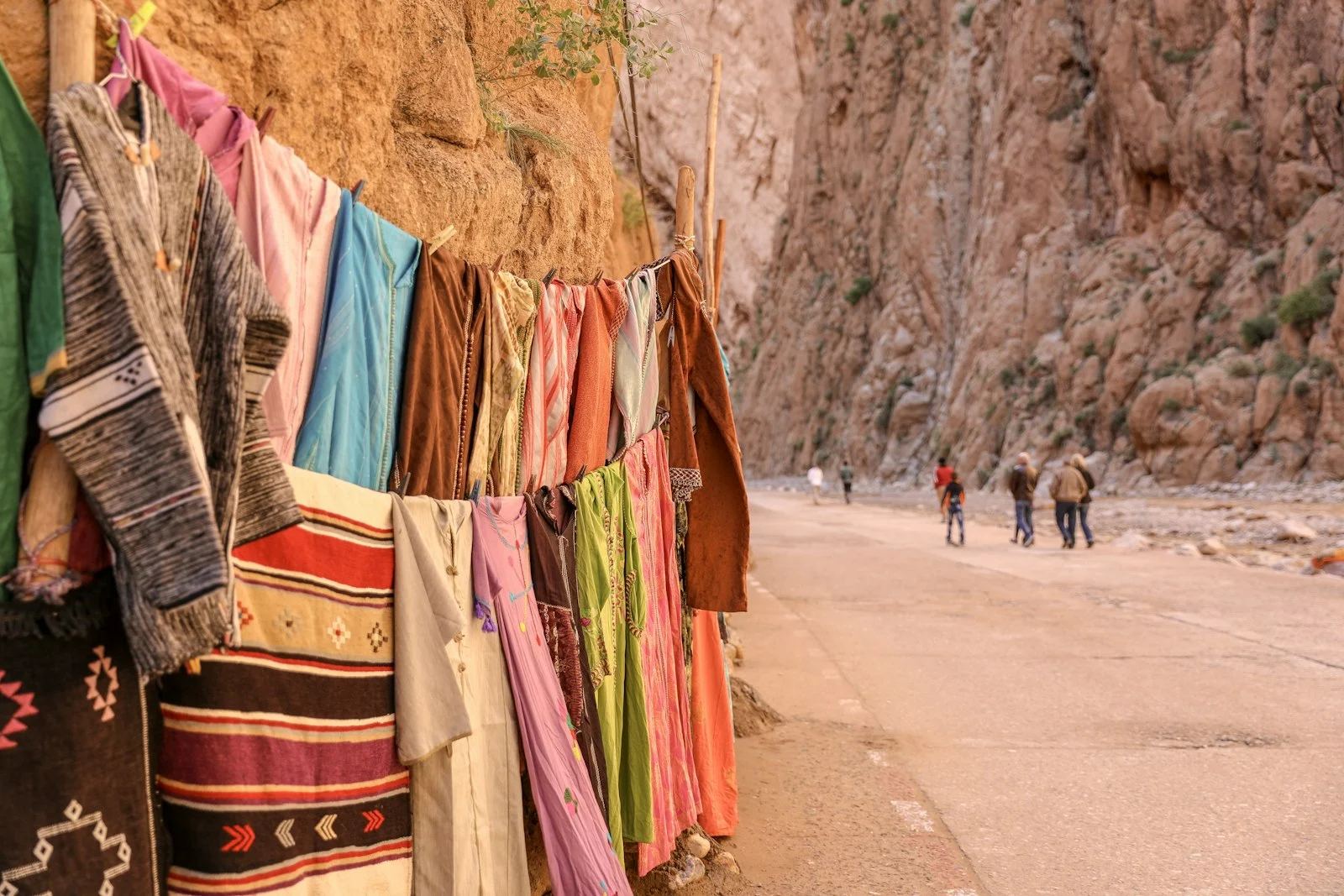 Colourful scarves displayed beside canyon walls in southern Morocco